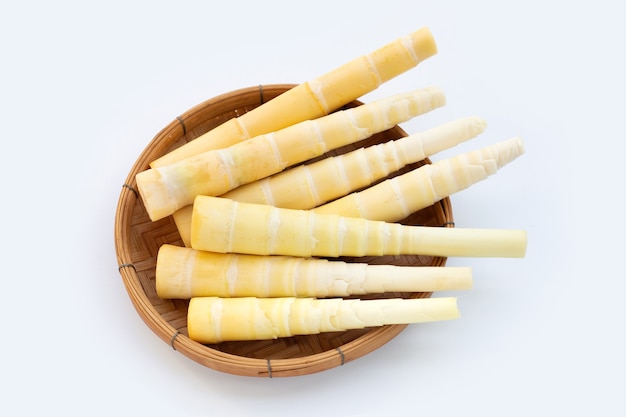 Bamboo shoots in bamboo basket on white background.