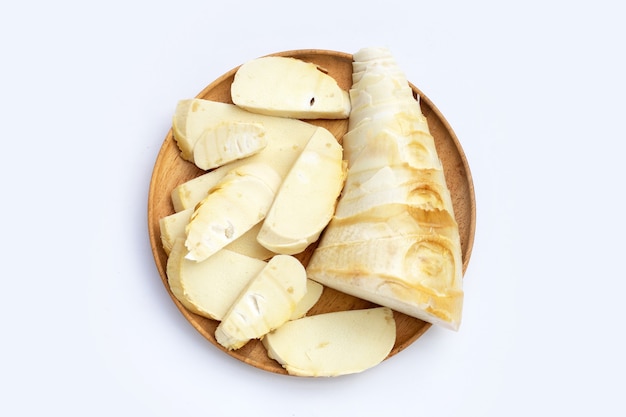 Bamboo shoots in wooden plate on white background