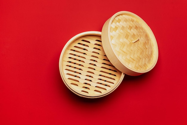 Bamboo steamer above view isolated on a red background