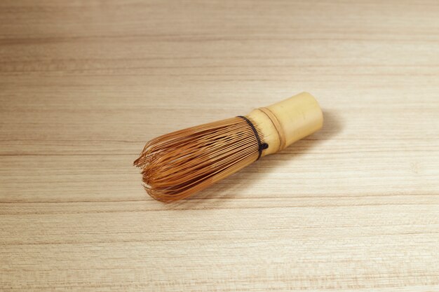 Bamboo tea whisk for matcha on wooden table