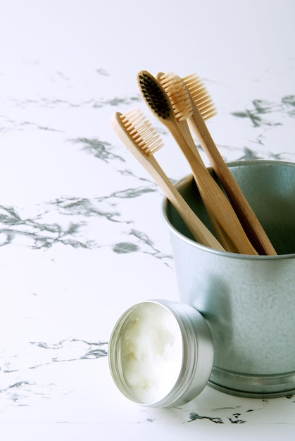 bamboo teeth brushes in bathroom on marbel background with copy space