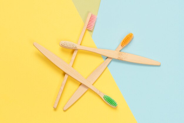 Bamboo toothbrush on a blue background. Top view.