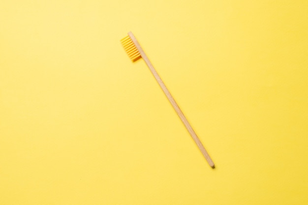 Bamboo toothbrush on a blue background. Top view.