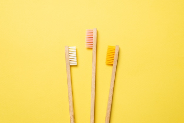 Bamboo toothbrush on a blue background. Top view.