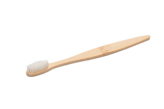 Bamboo toothbrush isolated on a white surface. Top view.