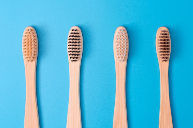 Bamboo toothbrushes on blue background