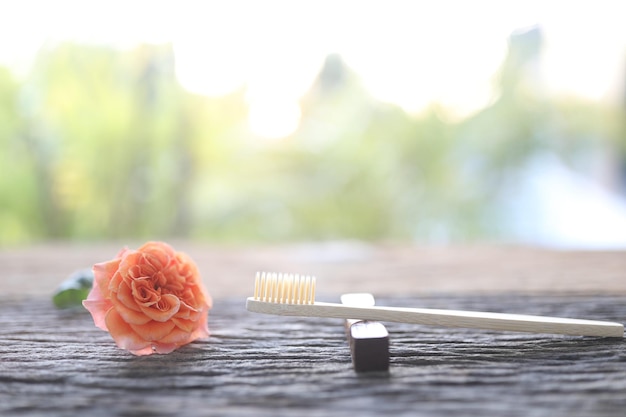 Bamboo wooden toothbrush and orange rose