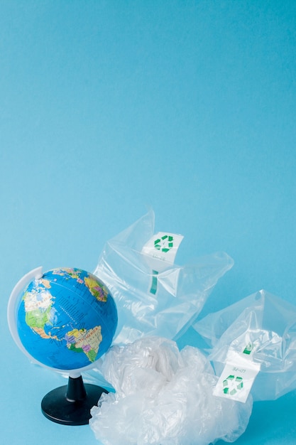 Ban plastic pollution. Globe and plastic bag out of the globe. Creative concept