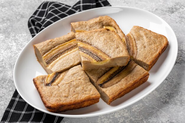 Banana bread on a light concrete background.