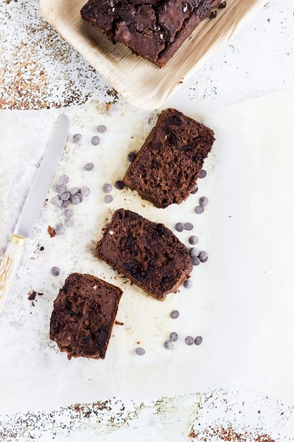 A banana bread and three pieces placed aside