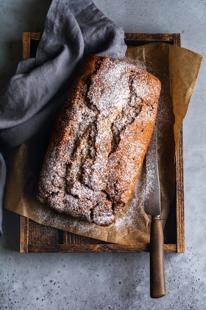 Banana bread with raspberry, bundt on gray concrete vintage surface