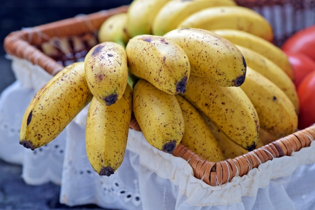 Banana bunch in fruit basket with white frill