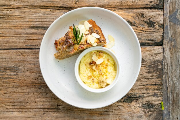 banana cake with cream cheese and crumble on plate