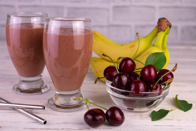 Banana and cherry chocolate smoothie in tall glasses