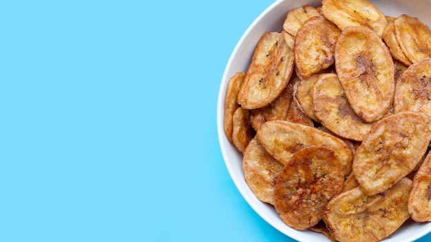 Banana chips on blue background