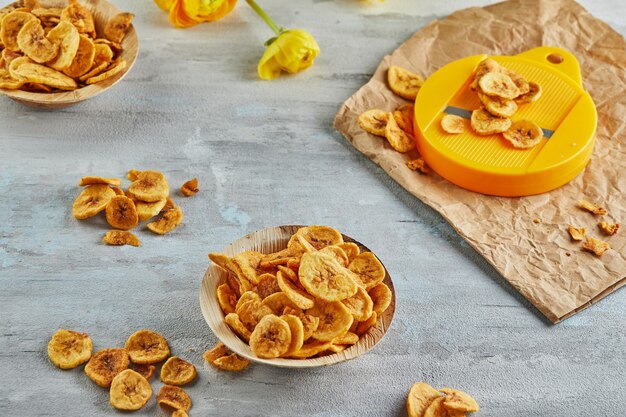 Banana chips healthy food, dry fruit and healthy vegetable chips, healthy vegan snack with chips cutter.