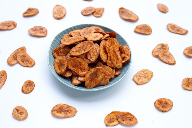 Banana chips on white surface