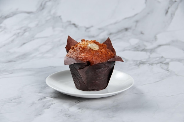Banana Custard Muffin Served in a dish side view on grey background