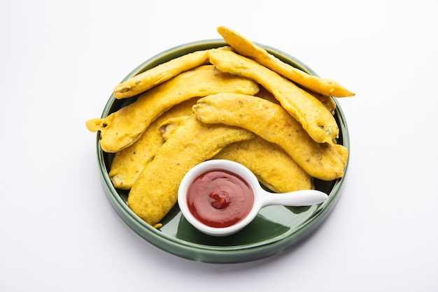 Banana Fritter or pakora or raw kela pakodaÃÂÃÂ or bajji served with chutney. Popular snack from Kerala, India or Indonesia. served with tea