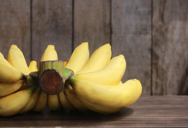 Banana fruit with wooden on blurred background