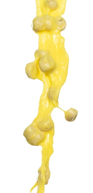 Photo banana juice flying fall down yellow banana chopped slice juice wave explode yellow paint color splash throwing in air white background isolated high speed shutter throwing freeze stop motion