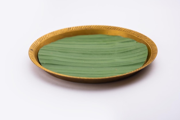 Banana leaf on blank plate for edit food or subject on