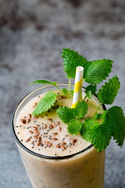 Banana and lemon smoothie, on the grey  table.