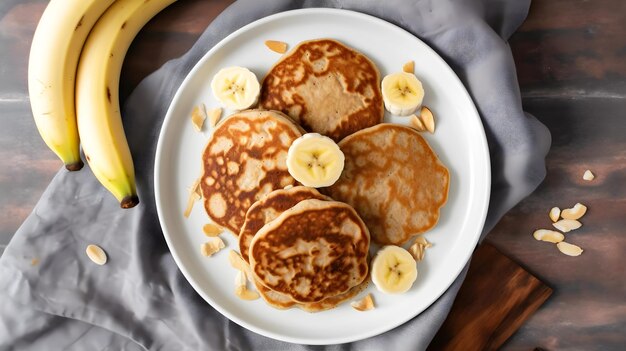 Banana pancakes on a plate with bananas on the side