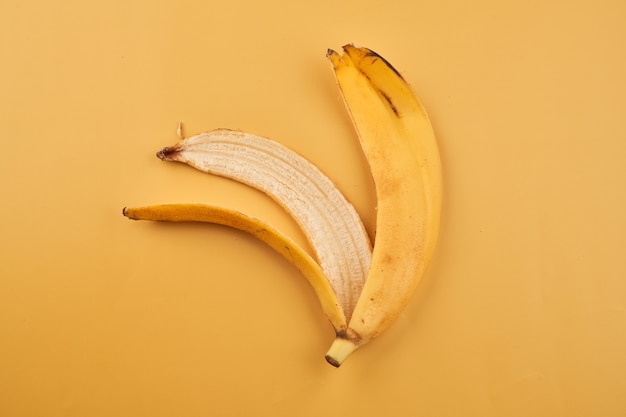 Banana peel isolated on yellow surface