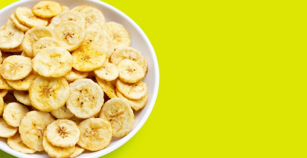 Banana slice chips on green background