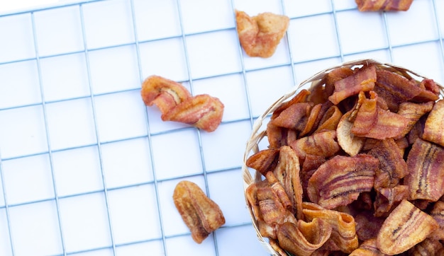 Banana slice chips on white background