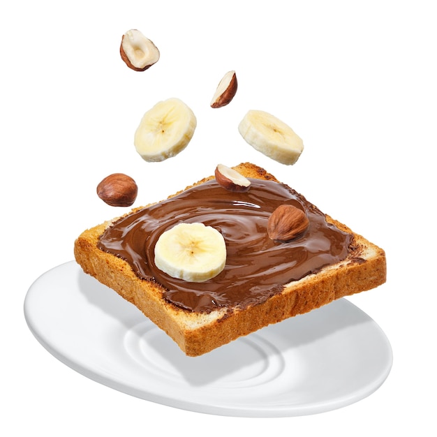 banana slices and hazelnut falling on toast with chocolate spread isolated on white background