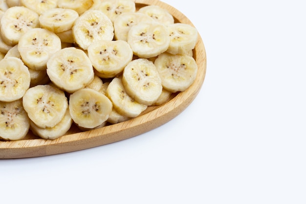 Banana slices in plate on white background.