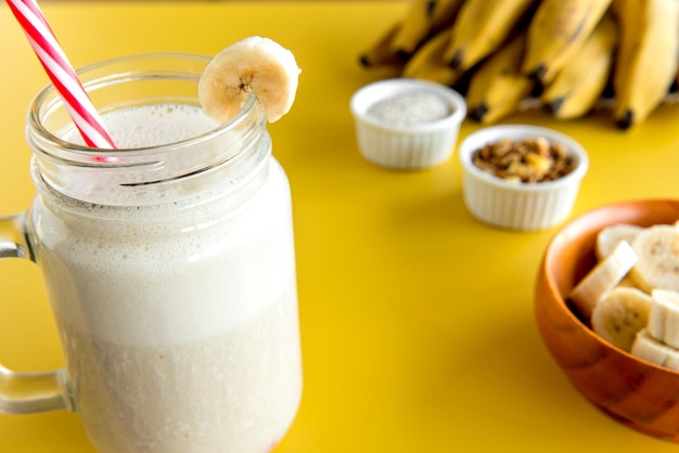 Banana smoothie cup healthy shake bananas in the background