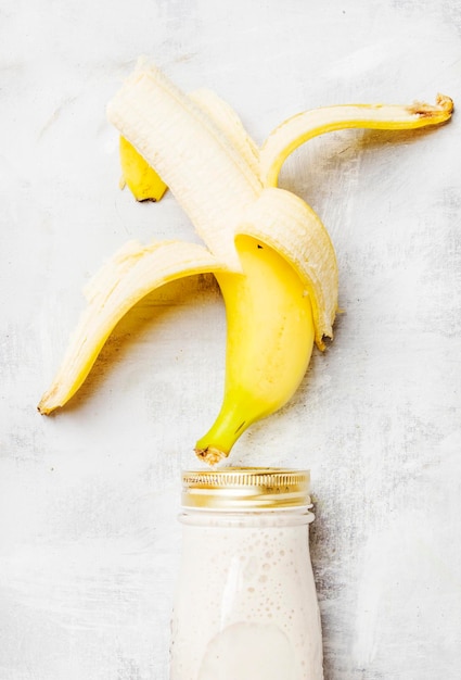 Banana smoothies in a bottle top view flat lay