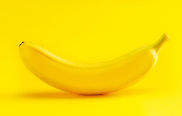 Banana on a yellow background closeup shot in the studio