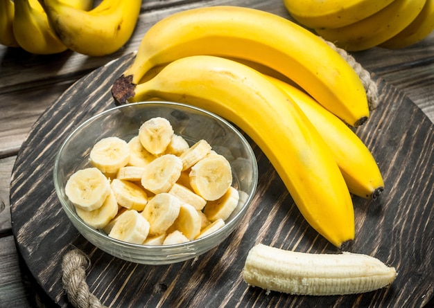 Bananas and banana slices in a glass bowl on the old dressing