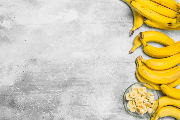 Bananas and banana slices in a glass plate