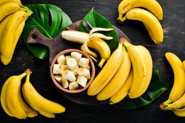 Bananas on a black wooden surface Tropical Fruits Top view Free copy space