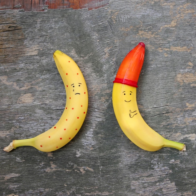 Bananas on the old wooden background. The concept of safe sex. Flat lay. Top view.