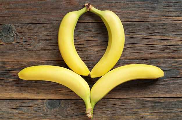 Bananas on a old wooden table, top view