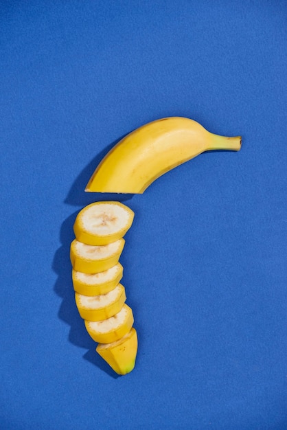 Bananas and slices isolated on a blue background