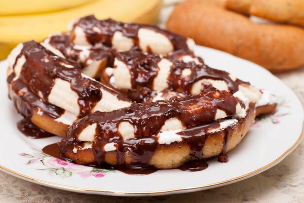 Bananas on toasted white bread with white cream and chocolate