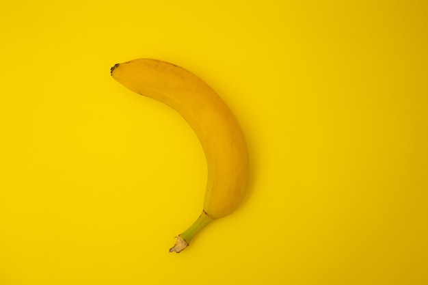 Bananas on yellow background monochrome