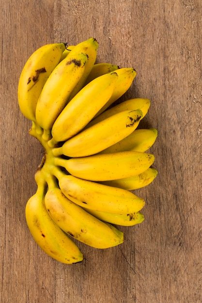 A banch of gold banana on wooden table