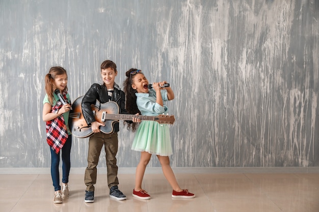 Band of little musicians against grunge wall