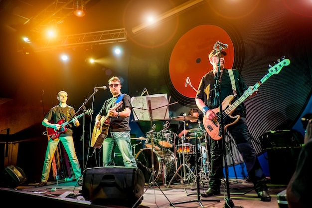 Band performs on stage, rock music concert in a nightclub