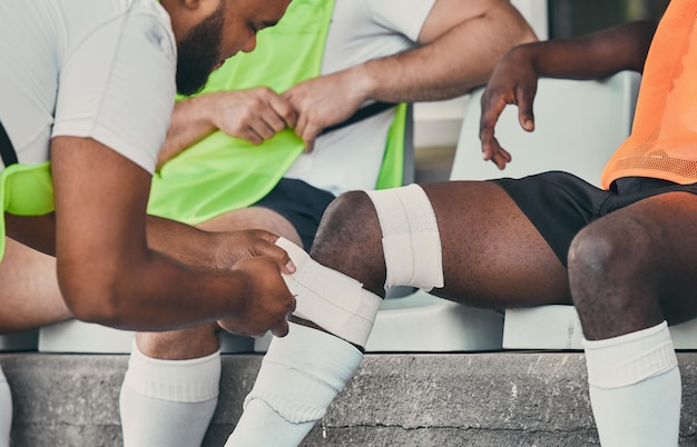 Photo bandage legs injury and man with medic after practice match training and sports game in stadium medical emergency health worker and rugby athlete with joint inflammation accident and tendinitis