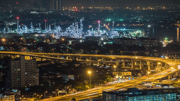 Foto città di bangkok, thailandia, mostrando il traffico sulla strada a motore e la raffineria di petrolio di notte