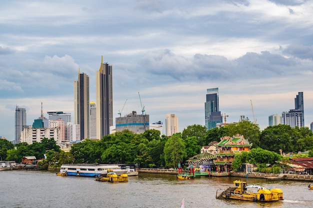 Bangkok Cityscape with Chinese Shrine beside the chaophraya river.Bangkok is the capital and most populous city of Thailand